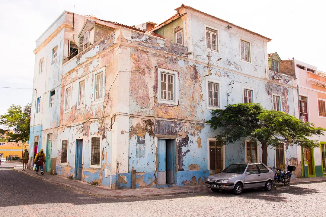 Weathered colonial building on a street corner in Mindelo